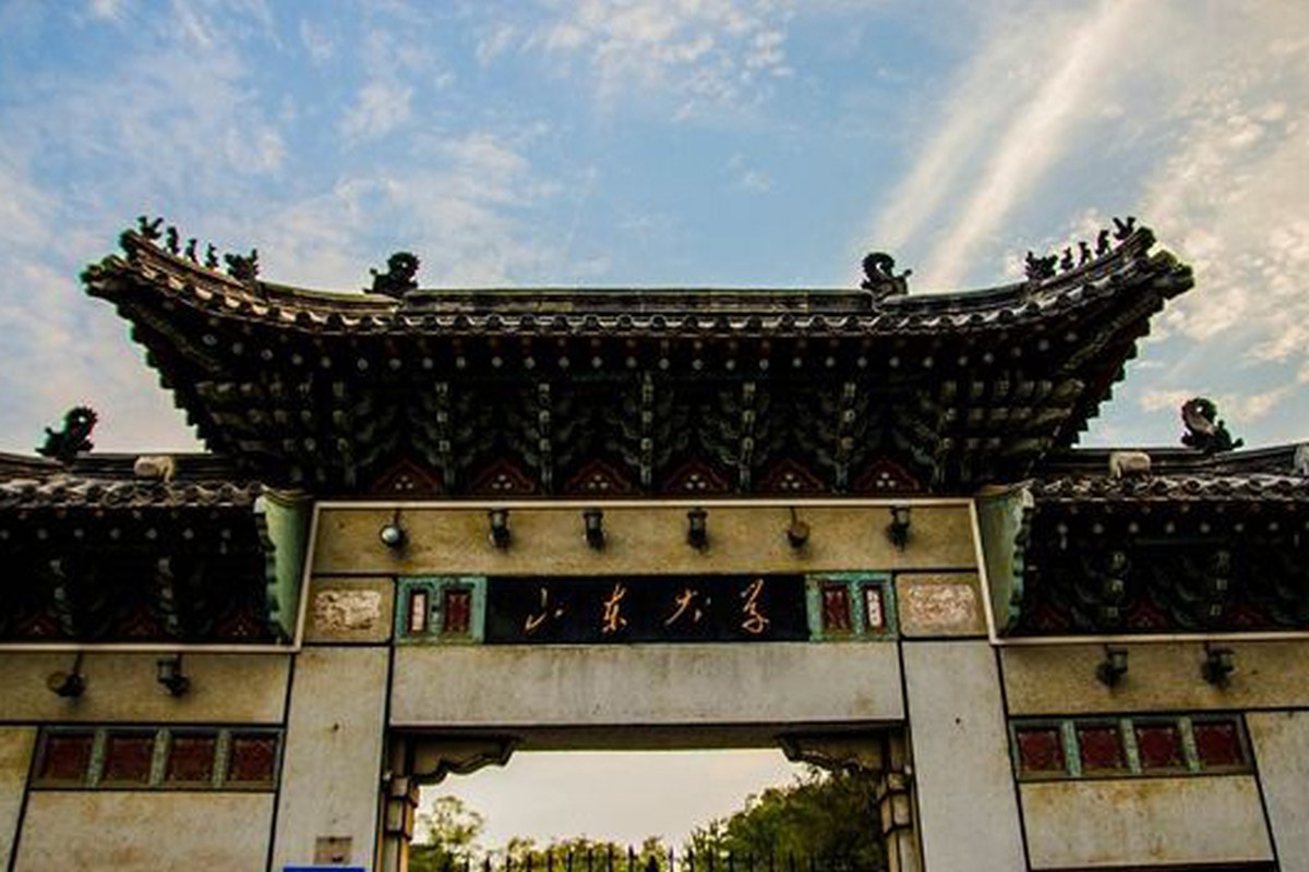 A traditional gateway framed by trees and decorative architectural details.