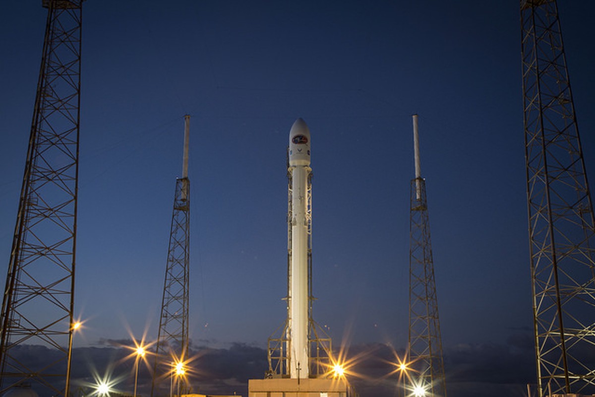 A rocket lifting from its launch pad into a clear evening sky.